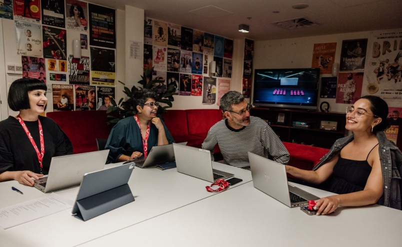 Q team members sitting around a table