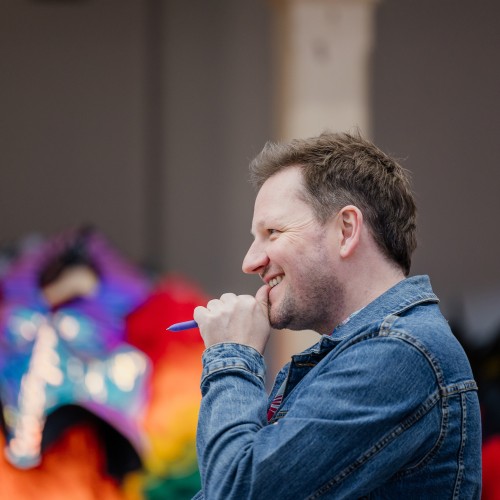 Director Daniel Williams watching rehearsals with a smile