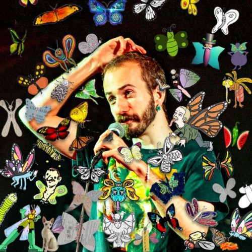 Benny Feldman stands speaking into a microphone wearing a green shirt agaisnt a black background. It's covered in colourful drawn butterflies. Text reads Benny Feldman's Butterfly Pavillion NZICF May 5 - 9 Auckland May 12 - 16 Wellington