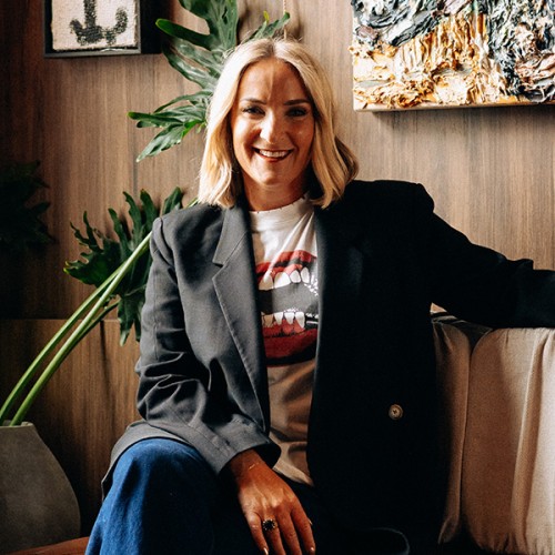 Brodie Kane in front of some plants and painting