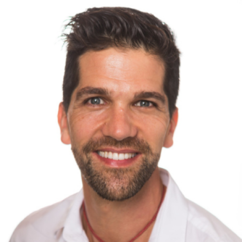 Photo of Simon Harger-Forde. He is smiling and wearing a white shirt.